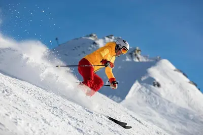 a person is skiing down a snow covered slope at Prarion - Modern apartment 4 pax Next to Ski lift - By Cozee Rentals in Les Houches