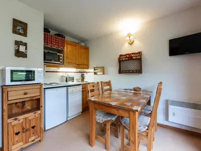 a living room with a couch and a large window at Les Eterlous - 8 - Appt Montagne 4-6 pers in Morillon