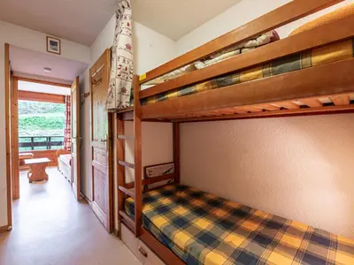 a bedroom with a bed with red pillows on it at Les Eterlous - 8 - Appt Montagne 4-6 pers in Morillon