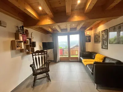 a living room with a couch and a chair at La Maison Magique! Magnifique chalet familial in Sallanches