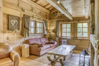 a living room with a couch and a table at Chalet Altitude in Megève
