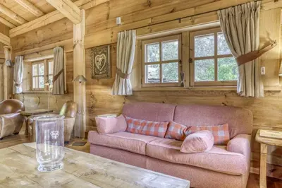 a living room with a couch and a table at Chalet Altitude in Megève