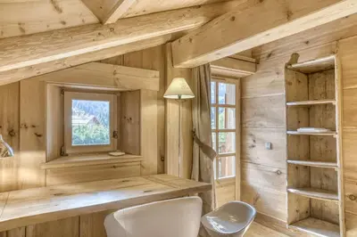 a bathroom with a white toilet and a window at Chalet Altitude in Megève