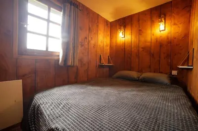 a bedroom with a bed in a room with a window at Ali'Home vue MontBlanc - T2 de charme in Demi-Quartier