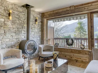 a living room with a table and chairs and a window at Appartement rénové 2 pièces, balcon, parking à Megève - FR-1-453-319 in Megève