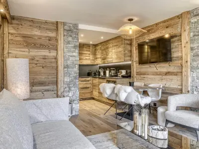 a living room with wooden walls and a table and chairs at Appartement rénové 2 pièces, balcon, parking à Megève - FR-1-453-319 in Megève