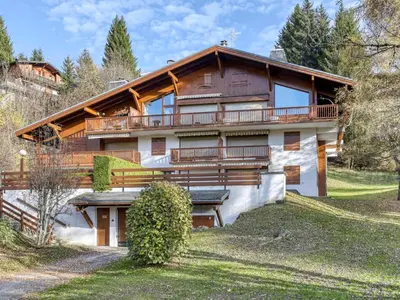 a large wooden house with a balcony on a hill at Appartement rénové 2 pièces, balcon, parking à Megève - FR-1-453-319 in Megève