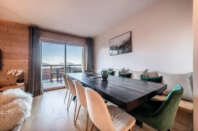 a dining room with a wooden table and chairs at Maira Les Carroz - by EMERALD STAY in Arâches-la-Frasse
