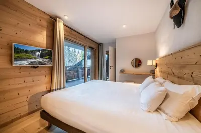 a bedroom with a large bed and a large window at Maira Les Carroz - by EMERALD STAY in Arâches-la-Frasse