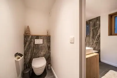 a bathroom with a toilet and a sink at Maira Les Carroz - by EMERALD STAY in Arâches-la-Frasse