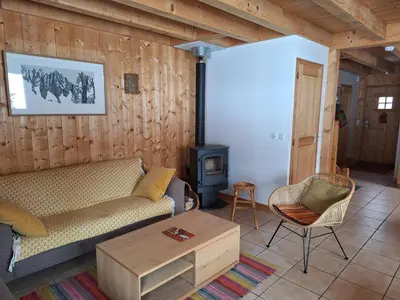 a living room with a couch and a stove at Chalet la Cry à St Gervais in Saint-Gervais-les-Bains