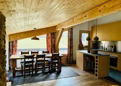 a kitchen and dining room with a table and chairs at Superbe appartement rénové 110m2 - 9 pers - vue montagne - Les Contamines in Les Contamines-Montjoie