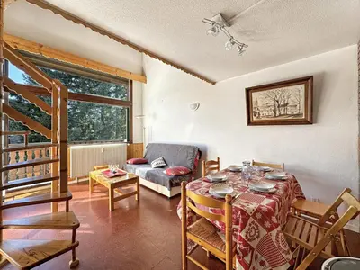 a living room with a table and a couch at CL339 - Appartement 6 personnes centre village in Les Carroz d'Araches