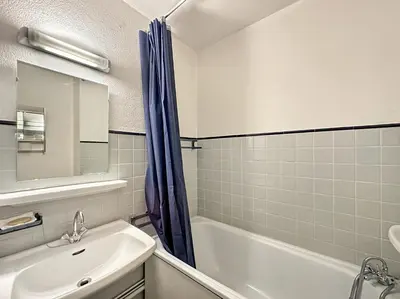 a bathroom with a sink and a tub and a shower at CL339 - Appartement 6 personnes centre village in Les Carroz d'Araches