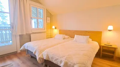 a bedroom with a large bed and a window at Les Chalets de Flaine Hameau - maeva Home - Chalet 4 pièces 6 personnes - Prestige MAE-3971 in Flaine