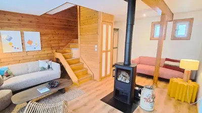 a living room with a wood stove in a house at Les Chalets de Flaine Hameau - maeva Home - Chalet 4 pièces 6 personnes - Prestige MAE-3971 in Flaine