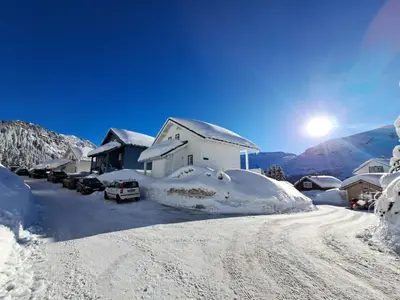 a snow covered street with a house and cars parked at Les Chalets de Flaine Hameau - maeva Home - Chalet 4 pièces 6 personnes - Prestige MAE-3971 in Flaine
