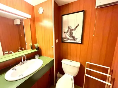 a bathroom with a toilet and a sink and a mirror at Studio Flaine à coté des pistes in Arâches-la-Frasse