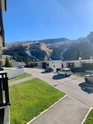 a parking lot with cars parked in front of a building at Studio Flaine à coté des pistes in Arâches-la-Frasse