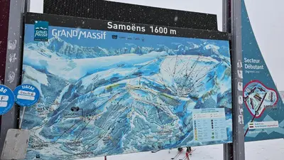 a large sign for a ski resort with a snow covered mountain at Ski1600 - GrandMassif in Samoëns