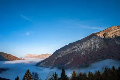 a view of a valley of clouds in the mountains at Ski1600 - GrandMassif in Samoëns
