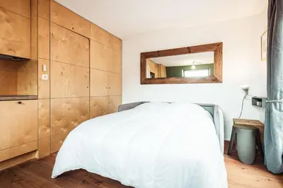 a bedroom with a white bed and a mirror at Vertice - Center Chamonix Mont-Blanc View in Chamonix-Mont-Blanc