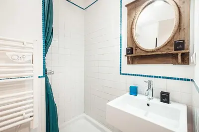a white bathroom with a sink and a mirror at Vertice - Center Chamonix Mont-Blanc View in Chamonix-Mont-Blanc