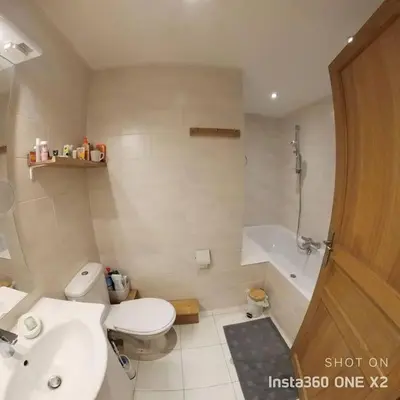 a bathroom with a toilet and a sink and a tub at Les montagnes sur le balcon in Chamonix-Mont-Blanc