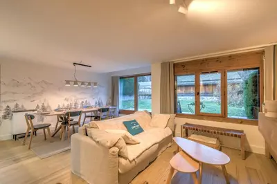a living room with a couch and a table at Appartement Sérénité - Welkeys in Chamonix-Mont-Blanc