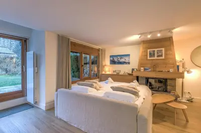 a bedroom with a bed with four pillows on it at Appartement Sérénité - Welkeys in Chamonix-Mont-Blanc