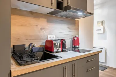a kitchen with a sink and a red appliance at Lachenal - Centre - Navette de ski - Balcon in Chamonix-Mont-Blanc