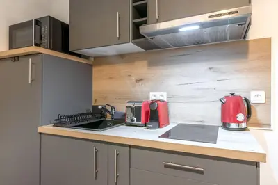 a kitchen with a red appliance on a counter at Lachenal - Centre - Navette de ski - Balcon in Chamonix-Mont-Blanc