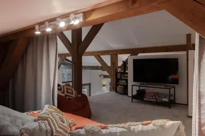 a living room with a large flat screen tv at Chalet des Eaux Rousses -Renove -Prive - Vues 360 Mont Blanc in Les Houches