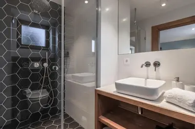 a bathroom with a sink and a shower at La Ferme du Mont in Servoz