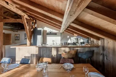 a dining room with a wooden table and chairs at La Ferme du Mont in Servoz