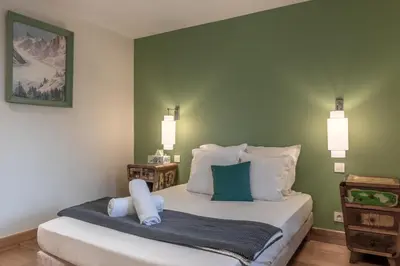 a bedroom with a bed with two pillows on it at La Ferme du Mont in Servoz