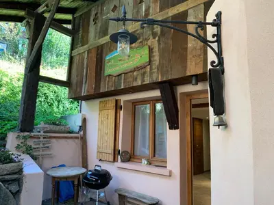 a building with a light on the side of it at La Ferme du Mont in Servoz