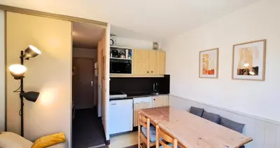 a small bed in a room with a light on the wall at Résidence Sirius - maeva Home - Studio 4 personnes - Confort MAE-3731 in Arâches-la-Frasse