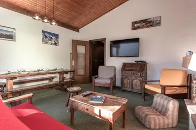 a living room with a couch and a piano at Cristal des Glaces - Balcon avec vue imprenable in Chamonix-Mont-Blanc