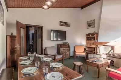 a living room with a table with plates on it at Cristal des Glaces - Balcon avec vue imprenable in Chamonix-Mont-Blanc