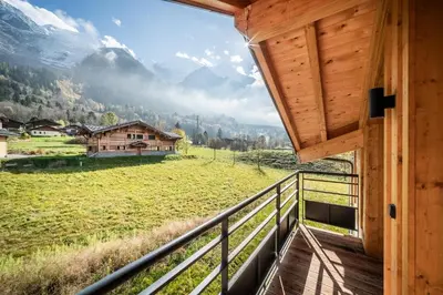 a balcony of a cabin with a view of the mountains at Chalet Ikigai Chamonix - by EMERALD STAY in Chamonix-Mont-Blanc