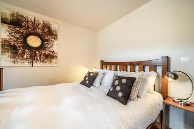 a bedroom with a white bed with pillows at Chalet Ibex Les Houches Chamonix - by EMERALD STAY in Les Houches