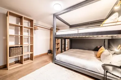 a bedroom with two bunk beds and a desk at Chalet Ibex Les Houches Chamonix - by EMERALD STAY in Les Houches