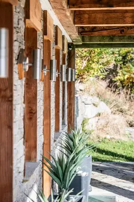 a house with a potted plant sitting on a porch at Chalet Ibex Les Houches Chamonix - by EMERALD STAY in Les Houches