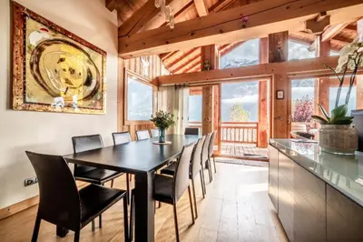 a dining room with a black table and chairs at Chalet Ibex Les Houches Chamonix - by EMERALD STAY in Les Houches