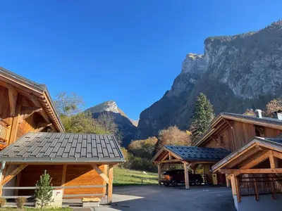 a group of buildings with mountains in the background at Appartement lumineux avec balcons, WIFI et parking à Samoëns - FR-1-624-172 in Samoëns