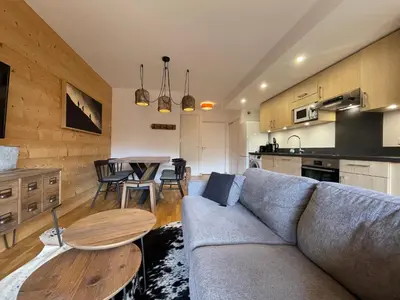 a living room with a couch and a table at Appartement lumineux avec balcons, WIFI et parking à Samoëns - FR-1-624-172 in Samoëns