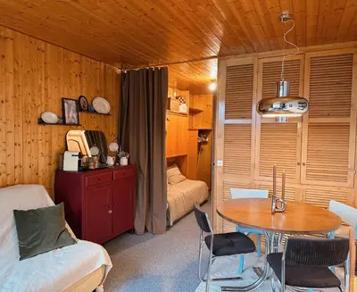 a bedroom with a bed and a table in a room at Blanches Alpes Appartement Megève in Megève