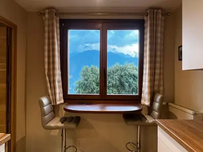 a window with a view of a mountain at Vue du Mont-Blanc in Passy