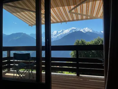 a view of mountains from a screened in porch at Vue du Mont-Blanc in Passy
